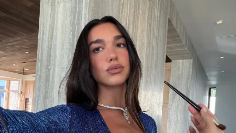 Dua Lipa Ignites the Night in Sultry Black Dress, Teasing Pink Bandeau and a Sky-High Slit