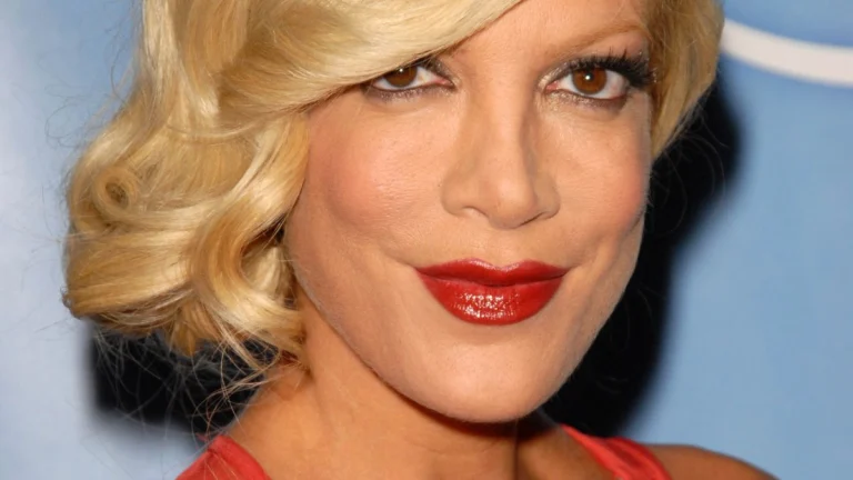 Tori Spelling (52) Stuns in Plunging Red Gown, Flaunting Cleavage and Toned Body at the iHeartRadio Music Awards